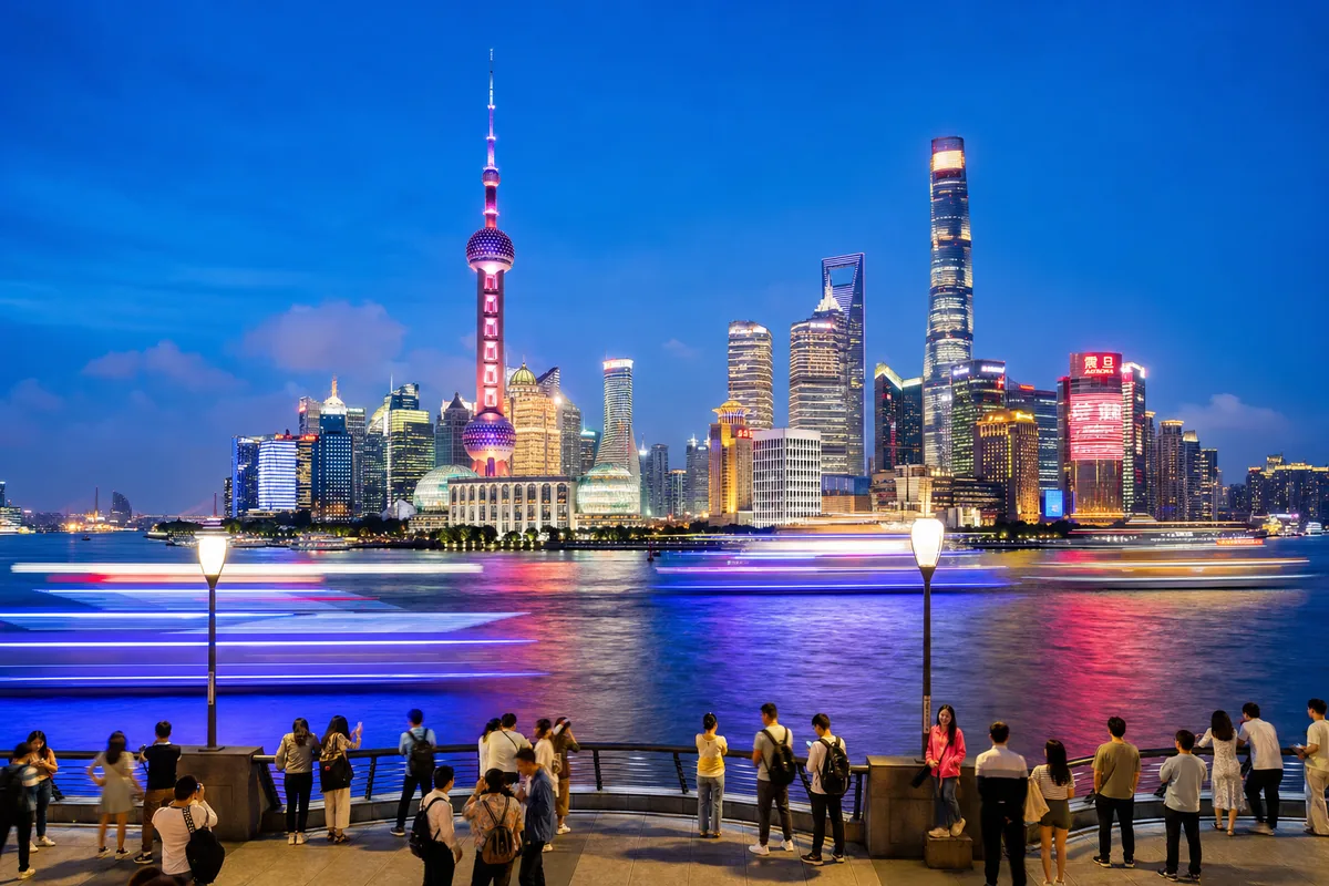 Shanghai Bund waterfront at dusk with the illuminated Pudong skyline