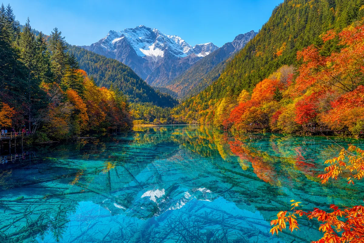 Turquoise lake at Jiuzhaigou reflecting red and gold autumn forest in Sichuan
