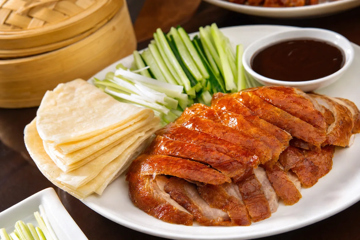 Sliced Peking duck served with thin pancakes, scallions, cucumber and sweet bean sauce