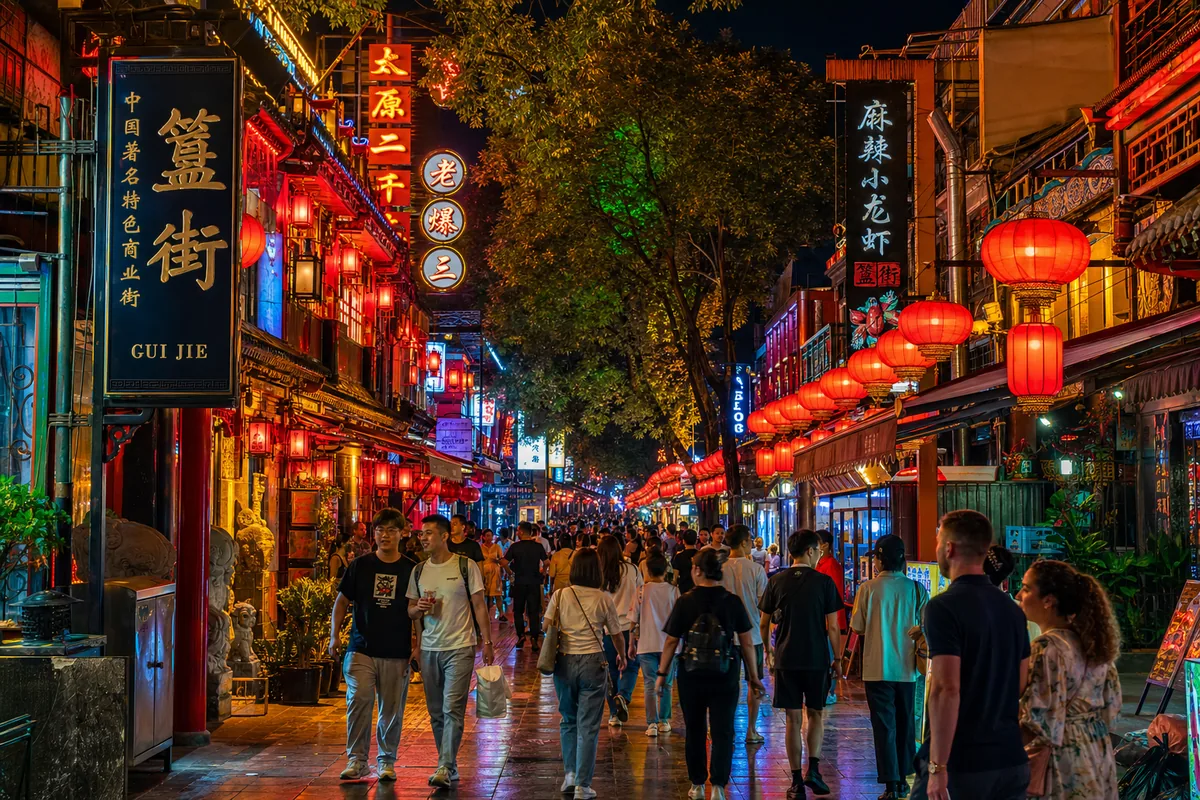 Guijie food street in Beijing at night lined with red lanterns and busy restaurants