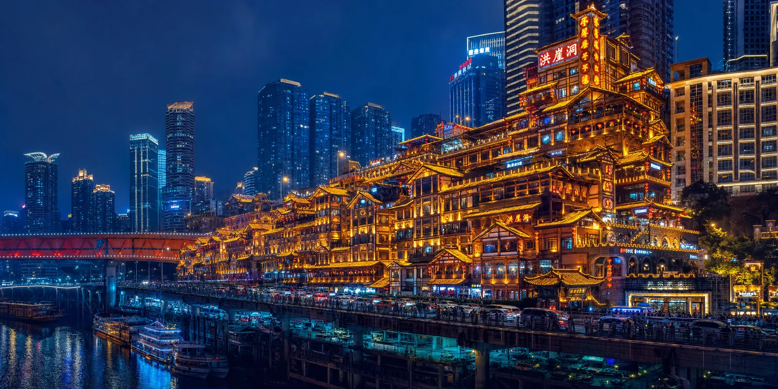 Hongya Cave stilt buildings lit up gold at night above the river in Chongqing