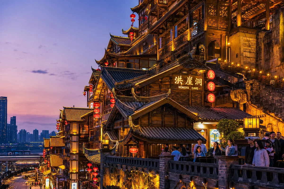 Close view of Hongya Cave's stacked wooden balconies at dusk with lights turning on