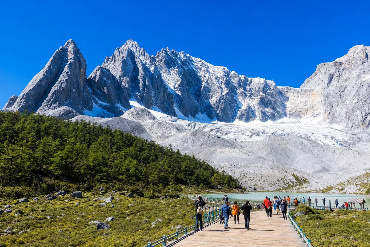 Snow-capped peaks of Jade Dragon Snow Mountain under a clear blue sky