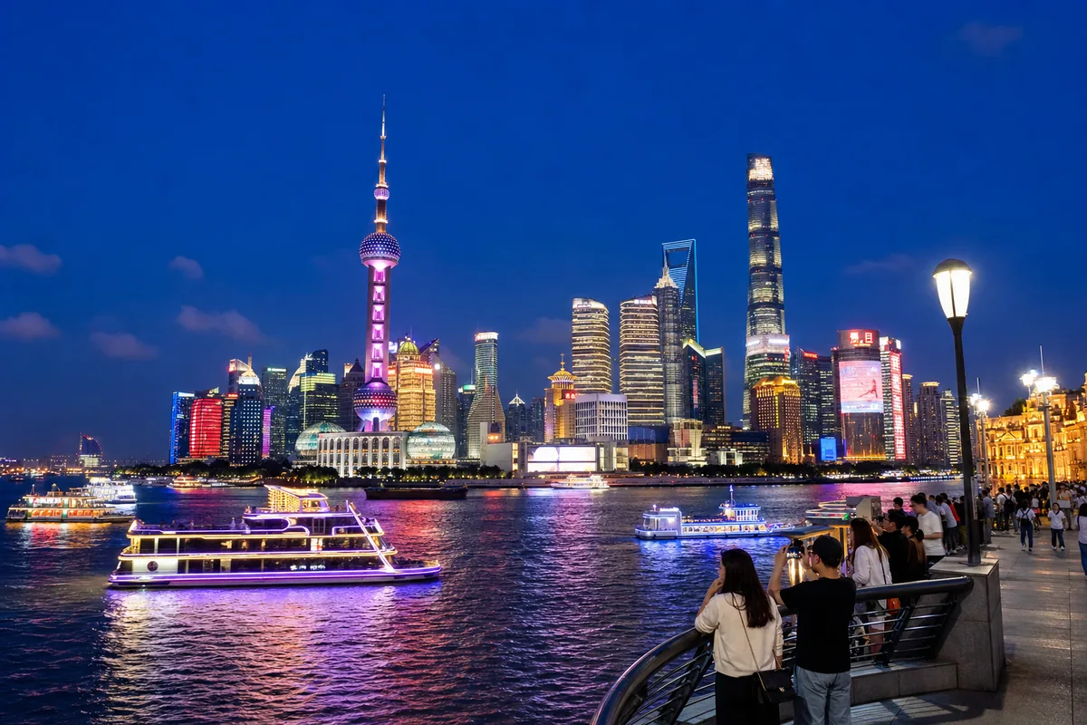 Shanghai Bund at night with historic buildings and the lit Pudong skyline across the river