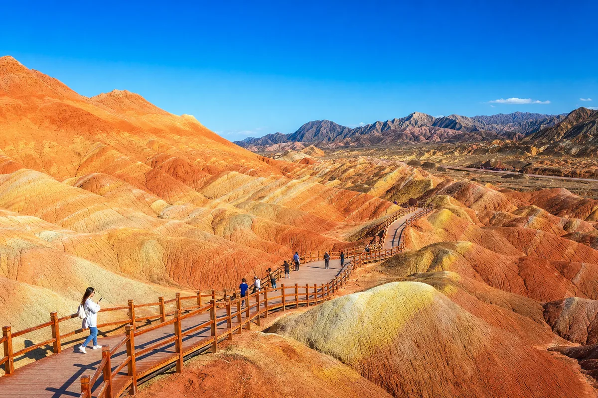 Vast colorful Danxia landforms in Northwest China under clear October skies with few tourists