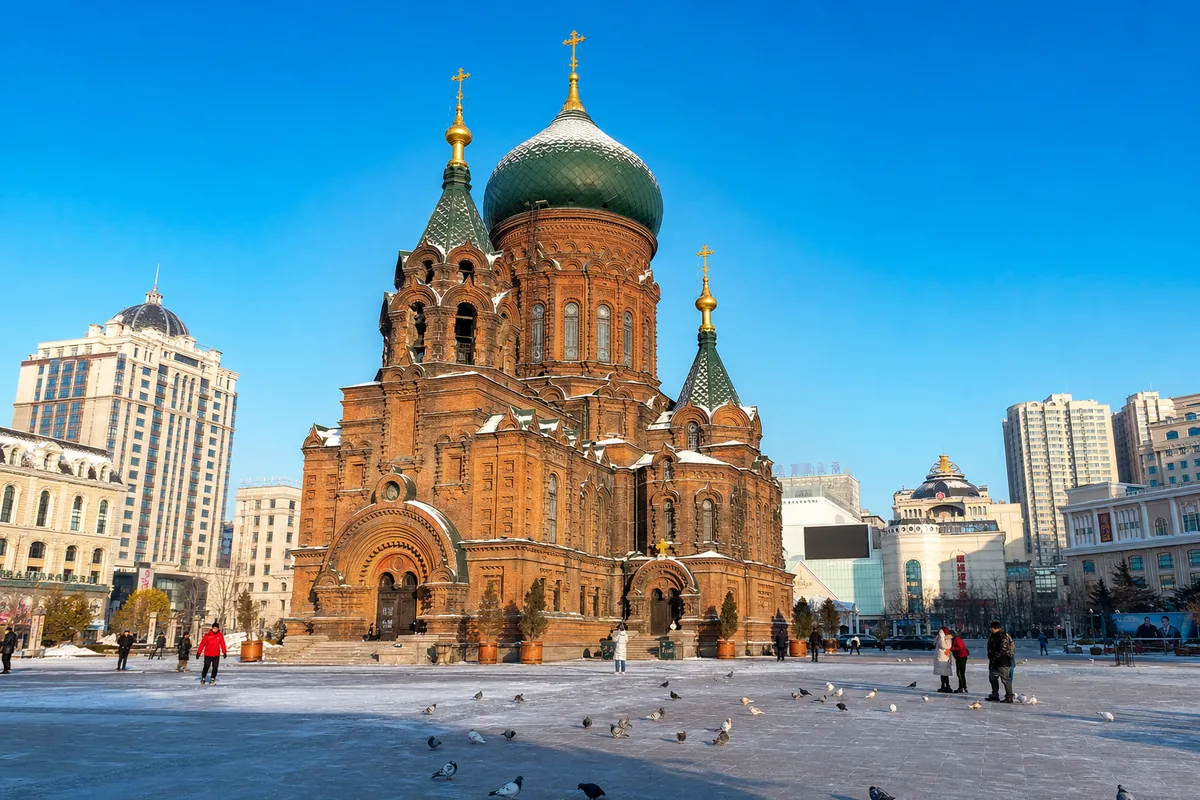 Saint Sophia Cathedral green dome and red brick against snow and blue sky in Harbin