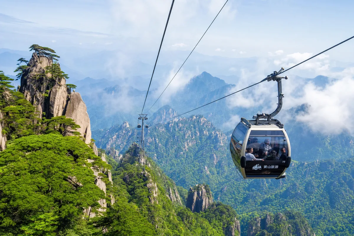 Cable car crossing a valley on Mount Huangshan above steep granite cliffs and pines