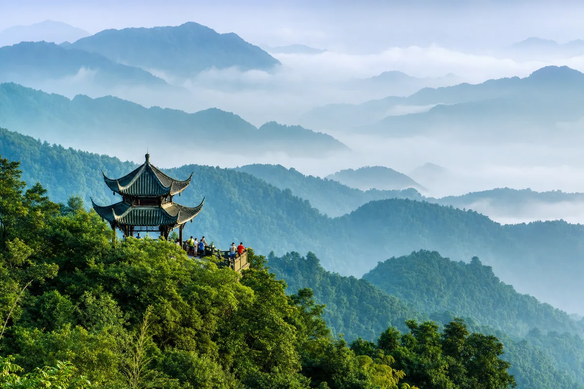 Misty forested ridges and a traditional pavilion on Mount Qingcheng near Chengdu