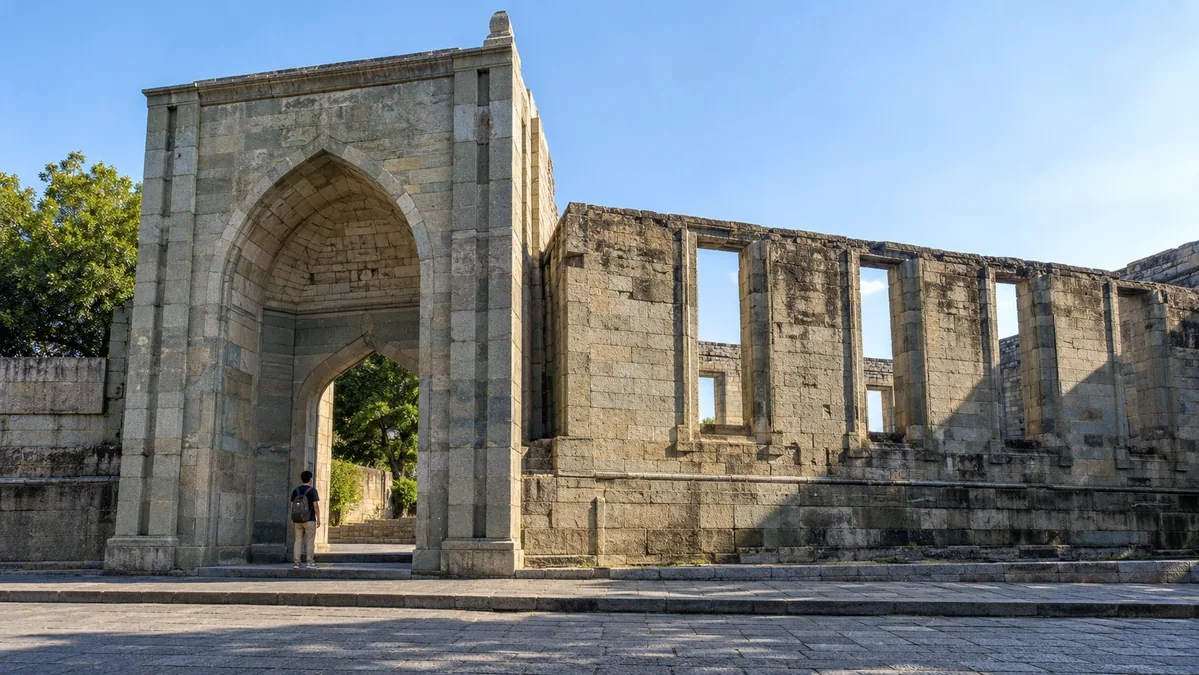 The tall granite gateway of Qingjing Mosque on Tumen Street in Quanzhou, with the roofless stone walls of the old prayer hall beside it