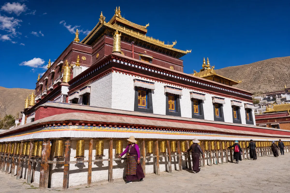 Labrang Monastery in Xiahe with white walls, golden roofs, and Tibetan pilgrims