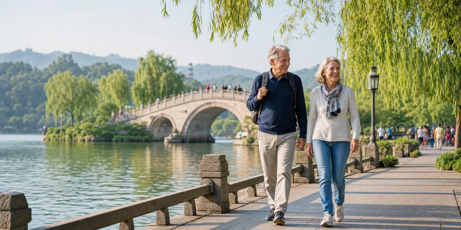 Older foreign couple walking calmly along a scenic Chinese lakeside in soft morning light