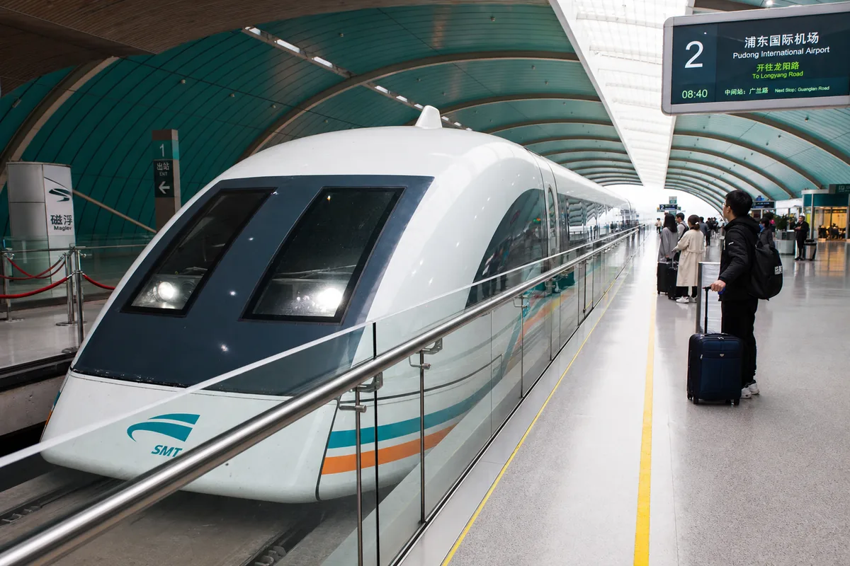 Shanghai maglev train at the Pudong Airport platform with passengers waiting