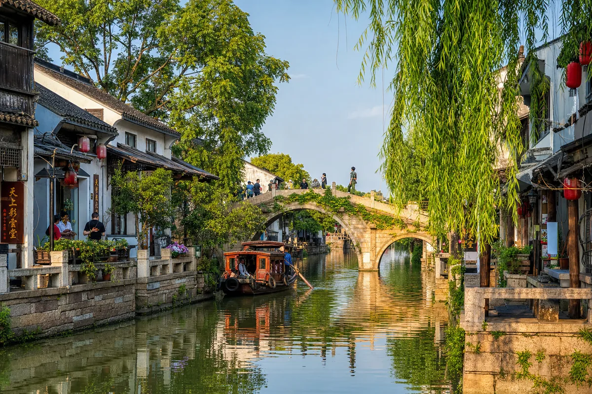 Canal with arched stone bridge and white-walled houses in Suzhou near Shanghai