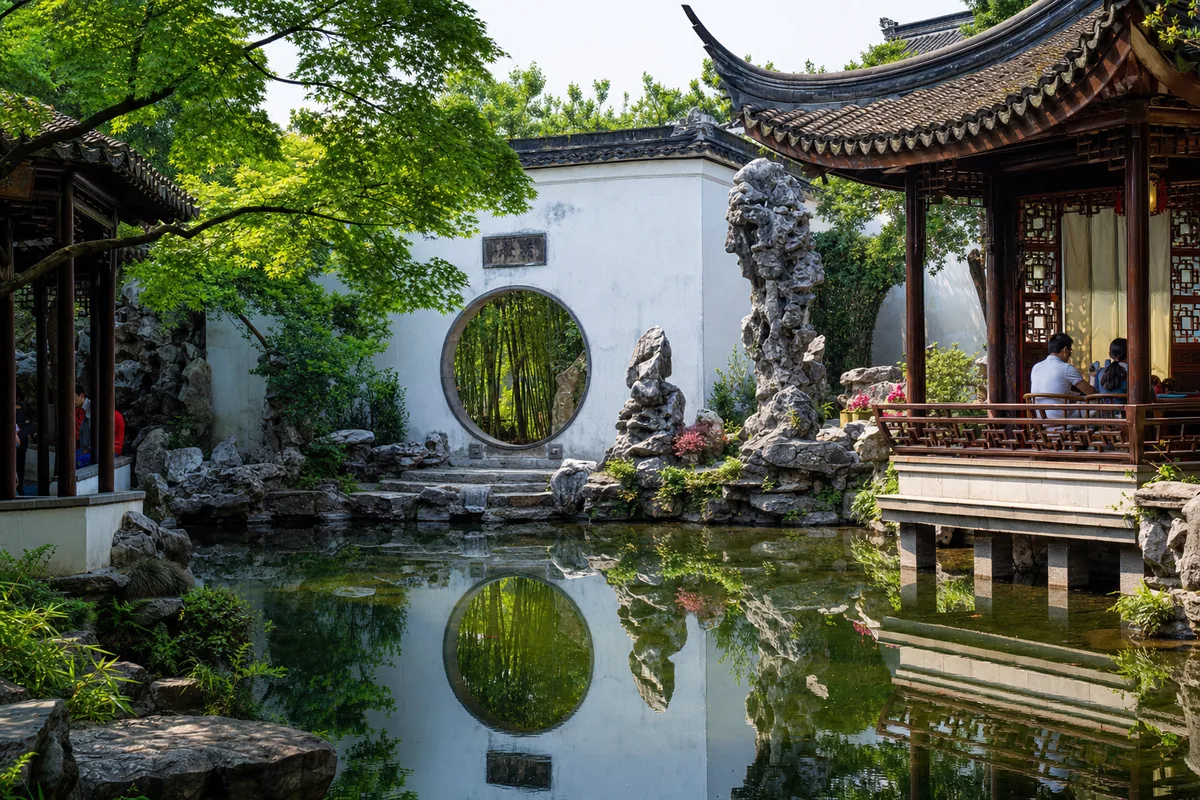 Classical Suzhou garden with a pavilion, pond, rockery and white walls