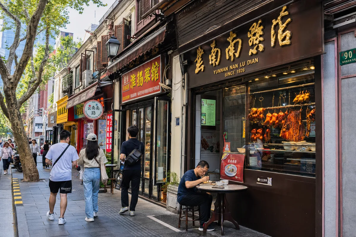 Storefronts and local diners along Yunnan South Road food street in Shanghai