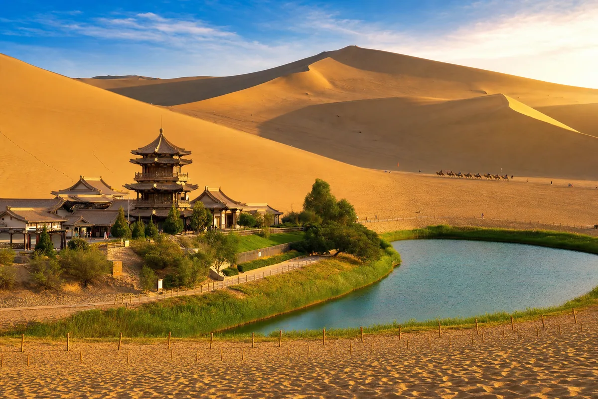 Crescent Lake oasis surrounded by sand dunes at Mingsha Mountain near Dunhuang