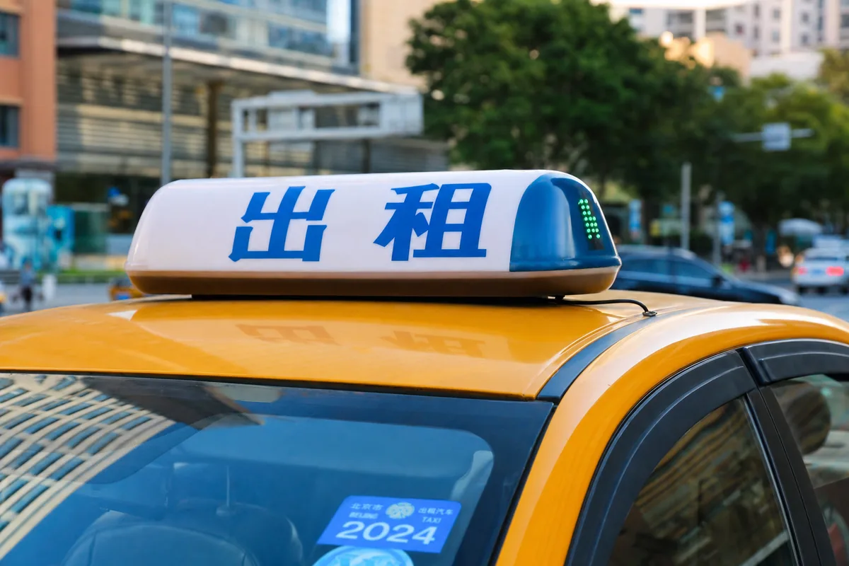 Close-up of a licensed Chinese taxi rooftop light showing the taxi sign