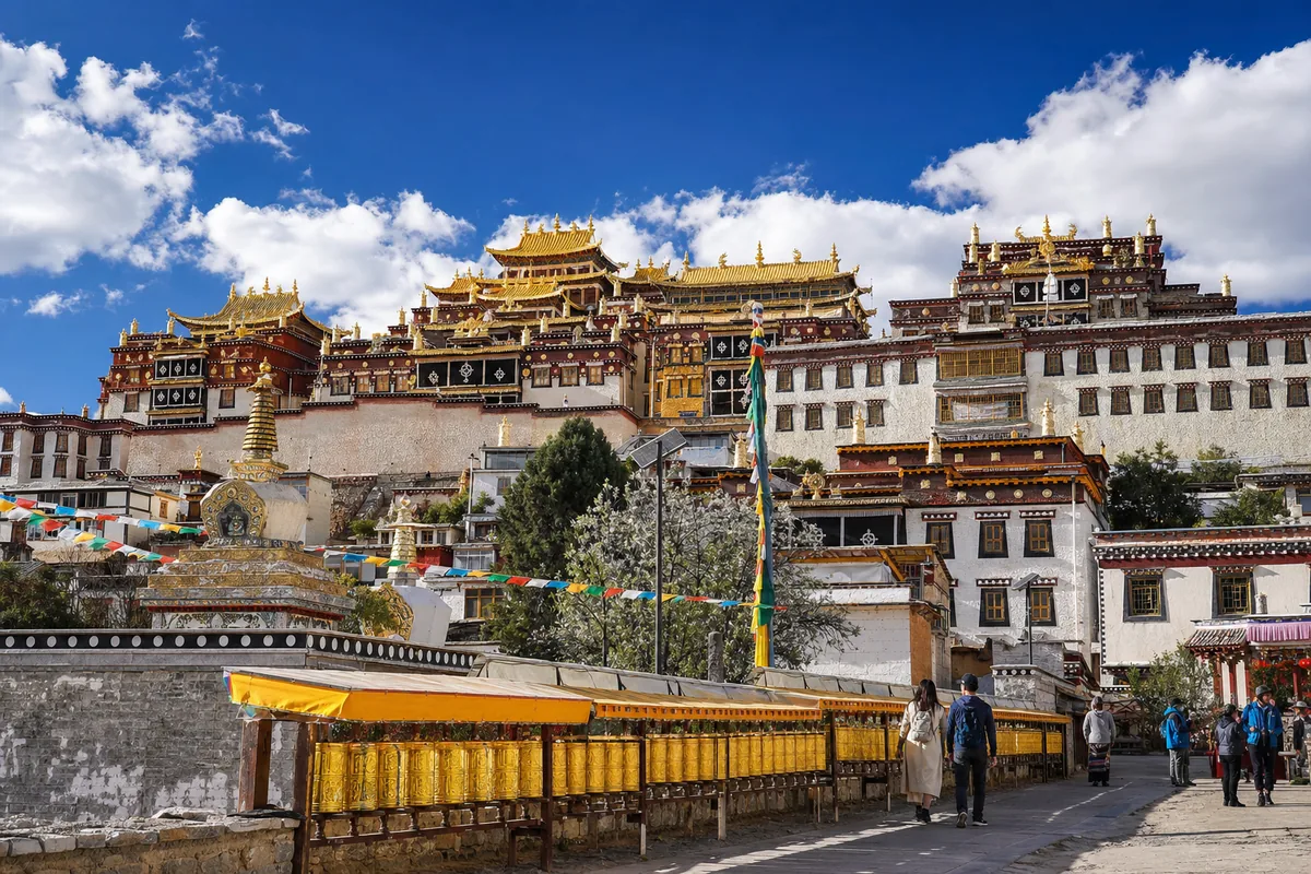 The golden roofs of Songzanlin Monastery in Shangri-La against a deep blue Tibetan plateau sky