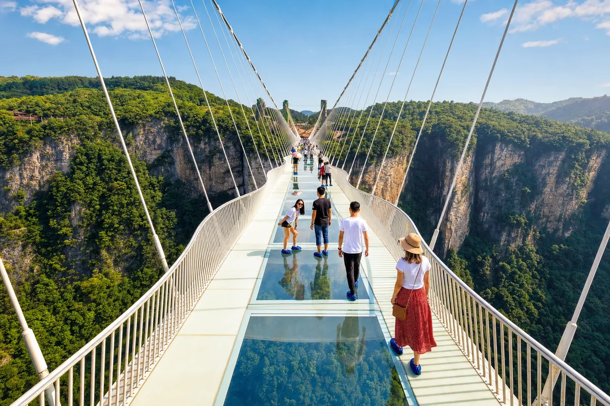 Visitors on the Zhangjiajie Glass Bridge high above the Grand Canyon